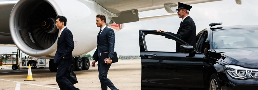 Professional chauffeur waiting at airport arrival terminal